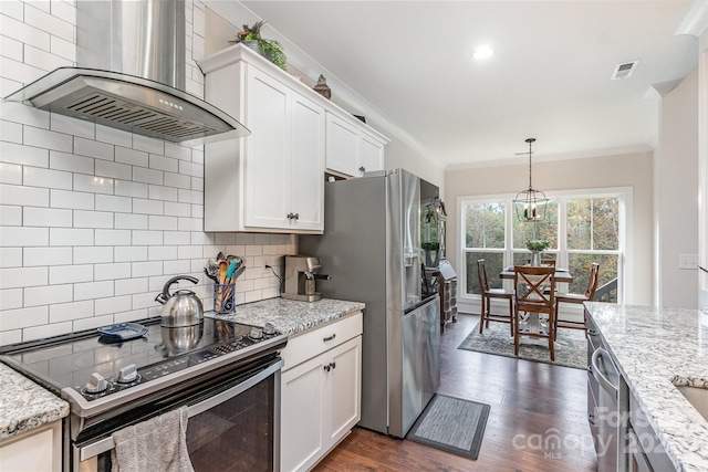 kitchen with dark wood-type flooring, wall chimney exhaust hood, appliances with stainless steel finishes, and white cabinets