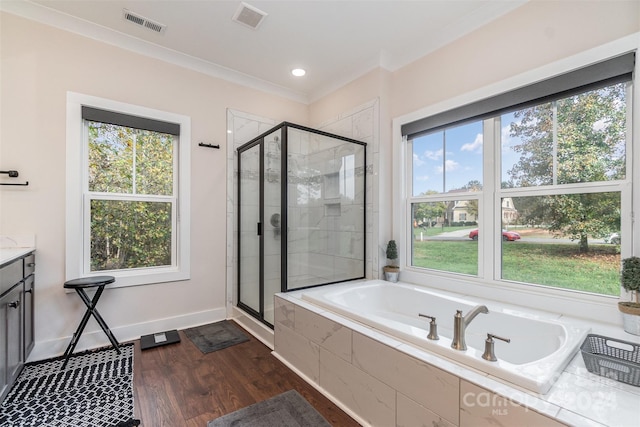 bathroom with vanity, ornamental molding, separate shower and tub, and hardwood / wood-style floors