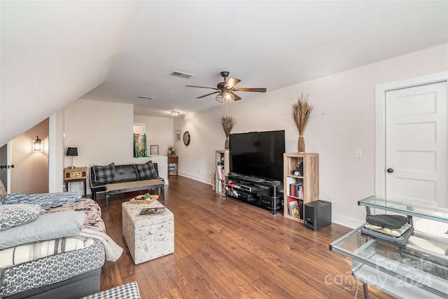 living room featuring ceiling fan, vaulted ceiling, and dark hardwood / wood-style flooring