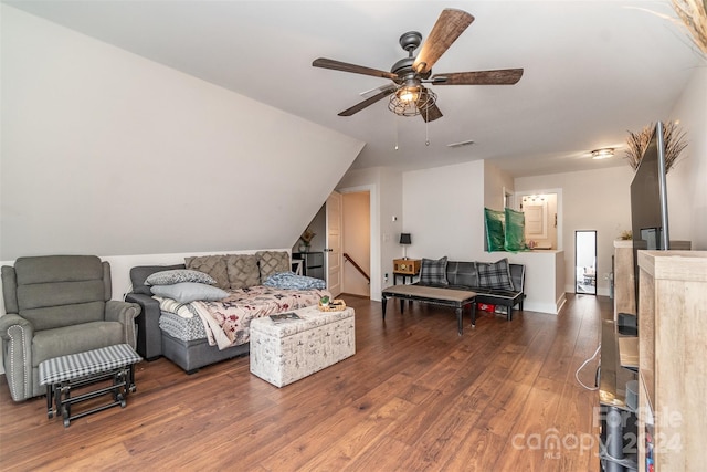 bedroom with dark wood-type flooring, vaulted ceiling, and ceiling fan