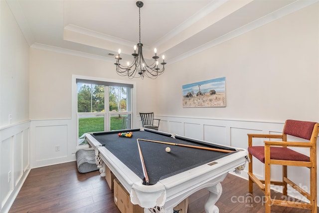 game room with a tray ceiling, crown molding, billiards, a chandelier, and dark hardwood / wood-style flooring