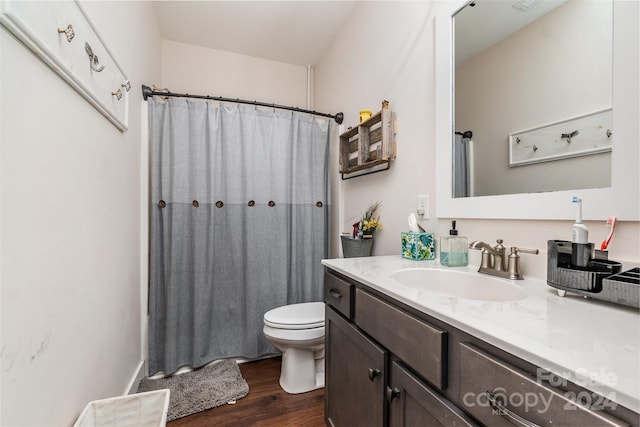 bathroom featuring vanity, toilet, wood-type flooring, and curtained shower