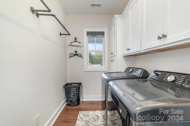 washroom with washer and clothes dryer, dark hardwood / wood-style floors, and cabinets