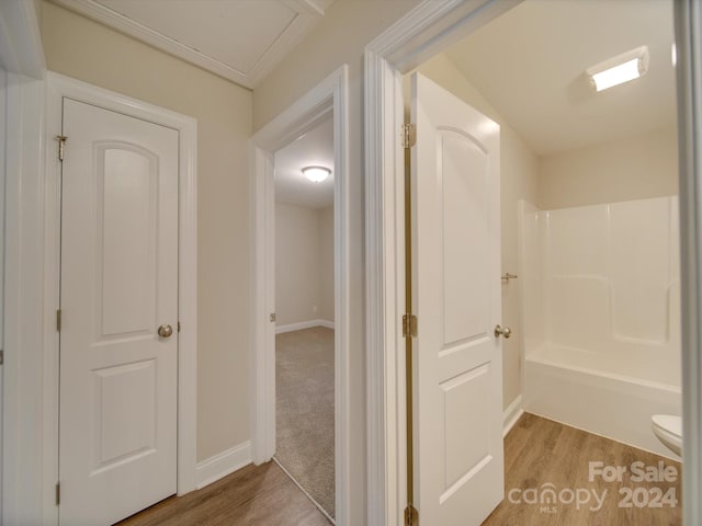 hallway with hardwood / wood-style flooring