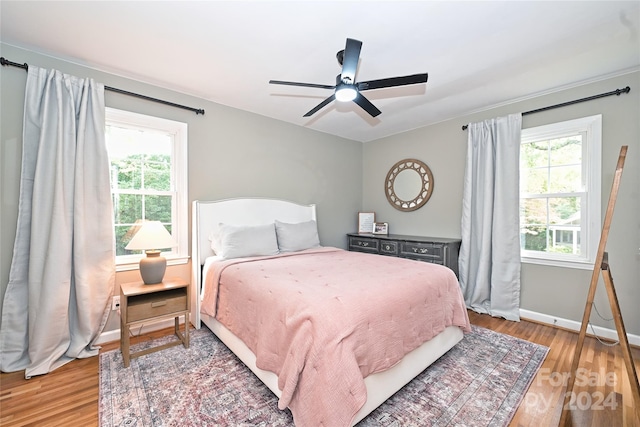 bedroom with ceiling fan and hardwood / wood-style flooring