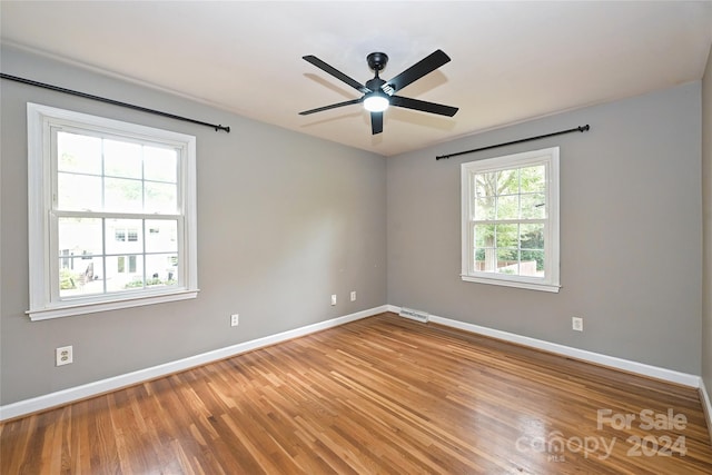 spare room with ceiling fan and hardwood / wood-style flooring