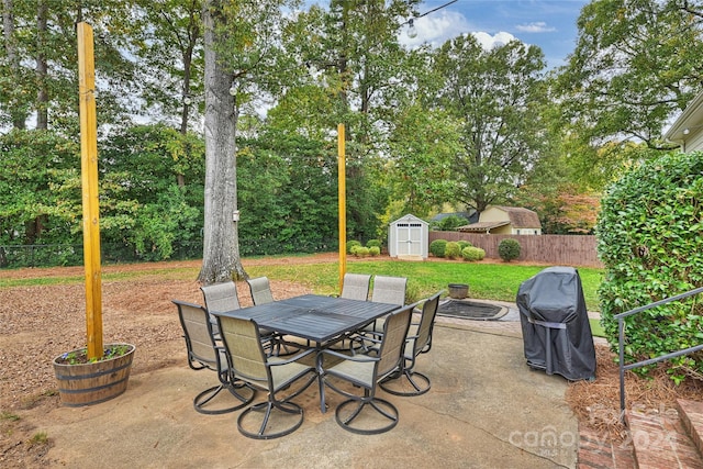 view of patio / terrace featuring a shed and a fire pit