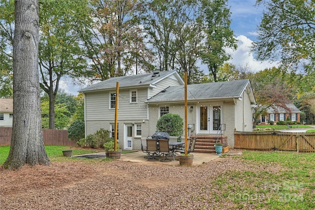 back of house with french doors and a patio area