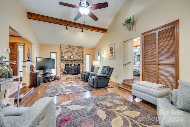 living room with beam ceiling, hardwood / wood-style flooring, high vaulted ceiling, and ceiling fan