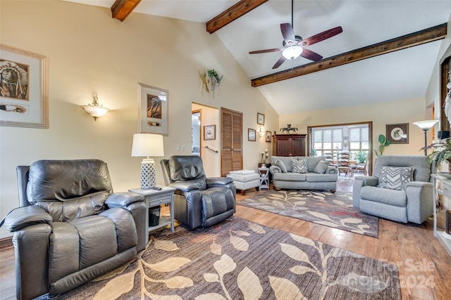 living room featuring hardwood / wood-style floors, beamed ceiling, high vaulted ceiling, and ceiling fan