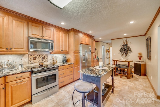 kitchen with crown molding, light stone countertops, appliances with stainless steel finishes, a textured ceiling, and tasteful backsplash