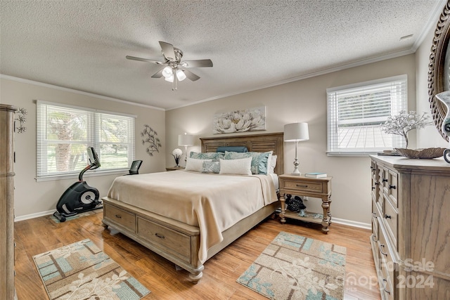 bedroom featuring crown molding, light wood-type flooring, and ceiling fan