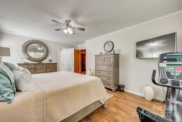 bedroom with crown molding, light hardwood / wood-style flooring, a textured ceiling, and ceiling fan