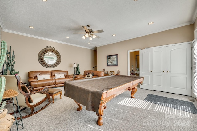 rec room with pool table, a textured ceiling, ceiling fan, ornamental molding, and light colored carpet