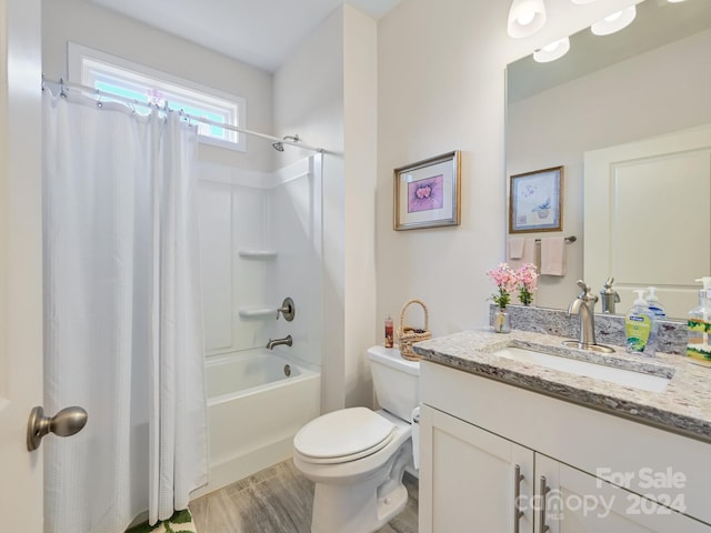 full bathroom with vanity, shower / bath combination with curtain, hardwood / wood-style flooring, and toilet