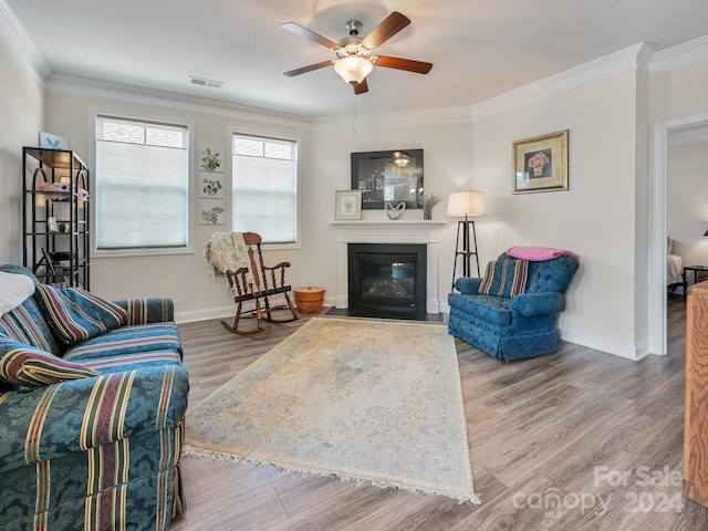 living room with ornamental molding, hardwood / wood-style floors, and ceiling fan