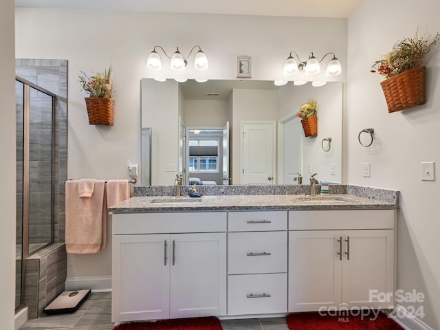 bathroom with vanity, an enclosed shower, and tile patterned floors