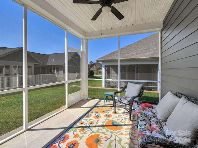 sunroom featuring wood ceiling and ceiling fan