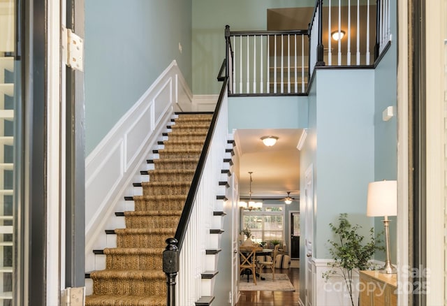 stairs featuring an inviting chandelier