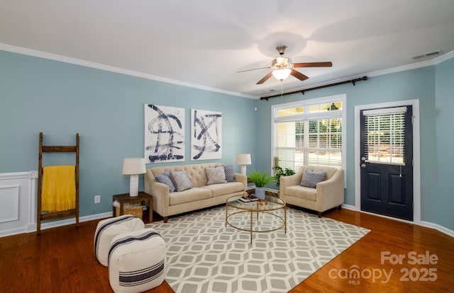 living room with wood-type flooring, ceiling fan, and crown molding