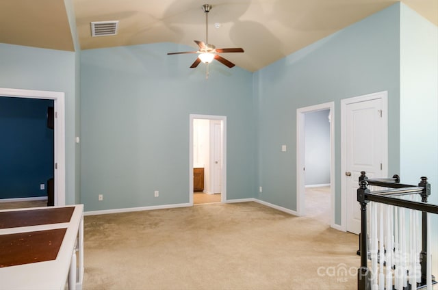 carpeted bedroom featuring ensuite bathroom, high vaulted ceiling, and ceiling fan