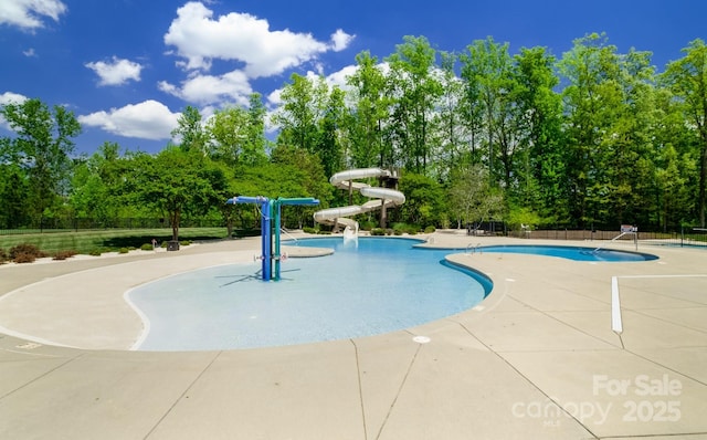 view of pool featuring a patio and a water slide