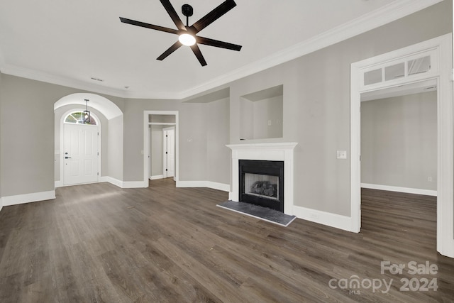 unfurnished living room featuring ornamental molding, ceiling fan, and dark hardwood / wood-style flooring