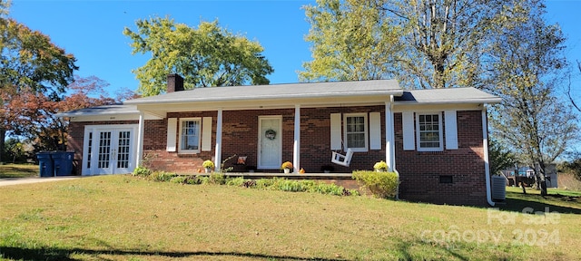 view of front of house featuring a front lawn and covered porch