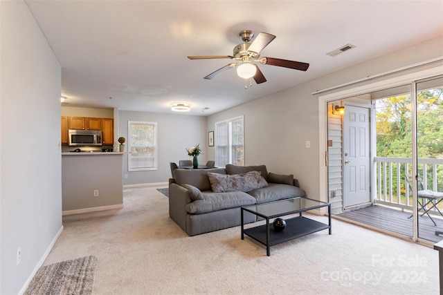 living room with ceiling fan and light carpet