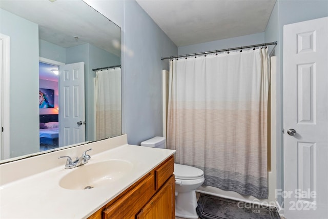 full bathroom with vanity, toilet, and shower / tub combo with curtain