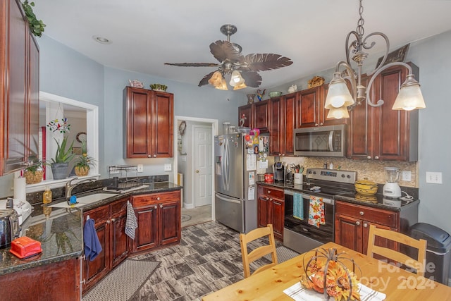 kitchen with decorative backsplash, ceiling fan, dark stone counters, sink, and stainless steel appliances