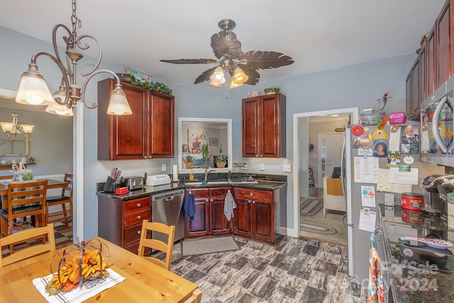 kitchen featuring stainless steel appliances, hanging light fixtures, and ceiling fan with notable chandelier