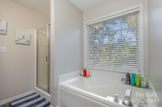 bathroom with separate shower and tub