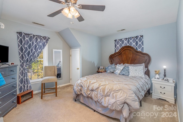 bedroom featuring lofted ceiling, light colored carpet, and ceiling fan