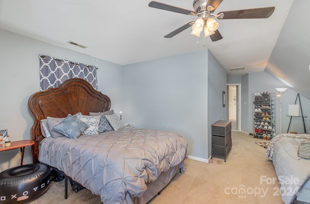 bedroom with light colored carpet, vaulted ceiling, and ceiling fan