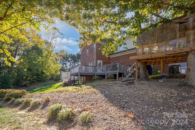 back of property with a wooden deck