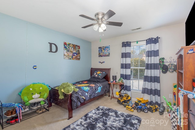 bedroom featuring ceiling fan, carpet, and multiple windows