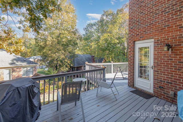 wooden terrace with a grill