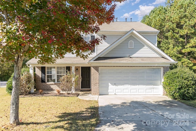 view of property featuring a front lawn