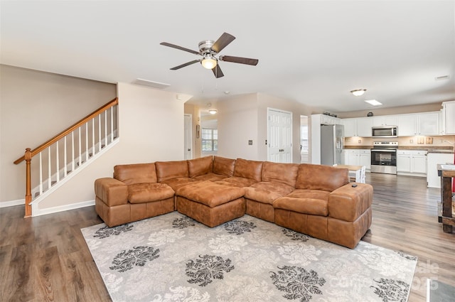 living room with hardwood / wood-style flooring and ceiling fan