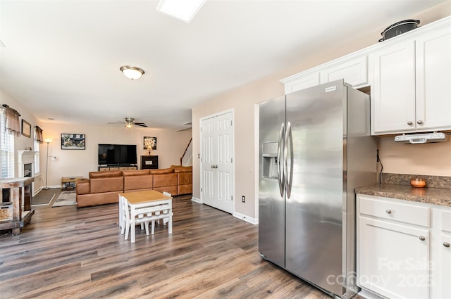 kitchen featuring ceiling fan, hardwood / wood-style flooring, white cabinets, and stainless steel refrigerator with ice dispenser