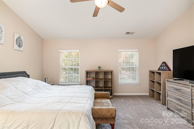 carpeted bedroom with vaulted ceiling and ceiling fan