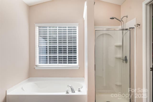 bathroom featuring independent shower and bath