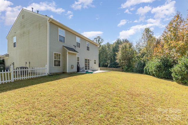 back of house with a yard and a patio area