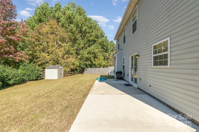 view of yard with a shed and a patio