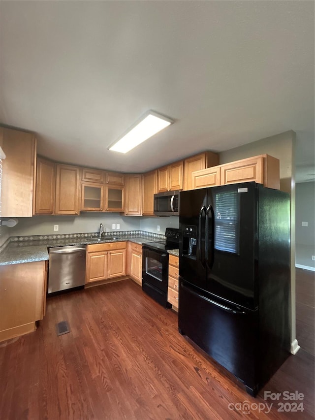 kitchen with black appliances, sink, light brown cabinets, and dark hardwood / wood-style floors