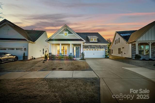 craftsman inspired home featuring covered porch and a garage