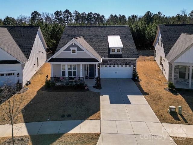 view of front of home featuring a garage, a porch, and a front yard