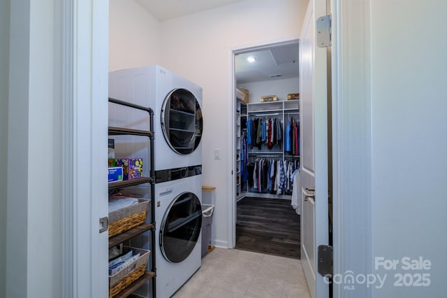 laundry area with stacked washer and dryer