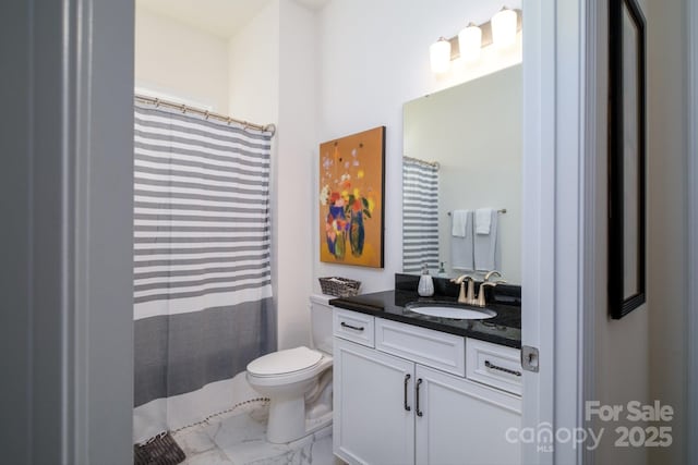 bathroom featuring toilet and vanity